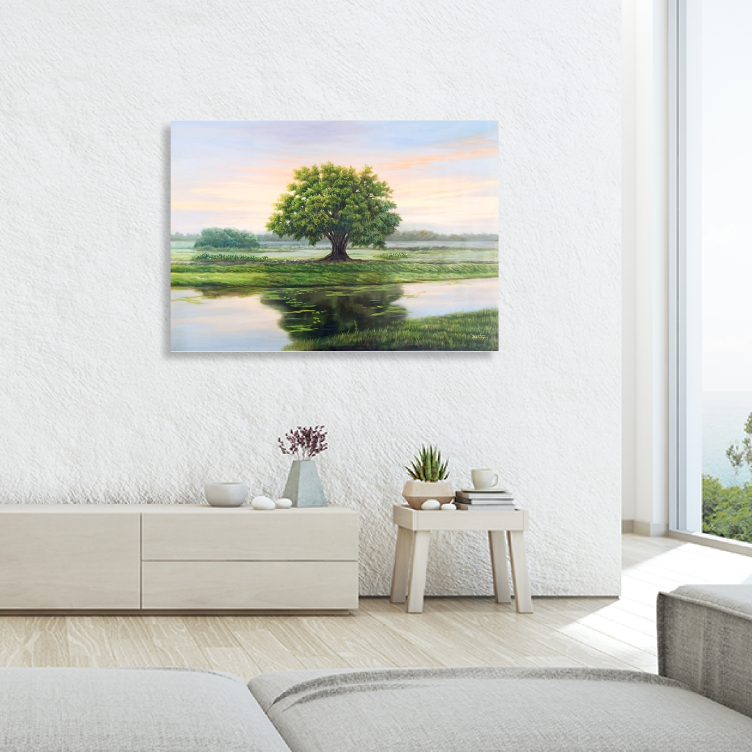 Oil painting features a single tree with green and yellow leaves, standing proudly on the bank of a calm river